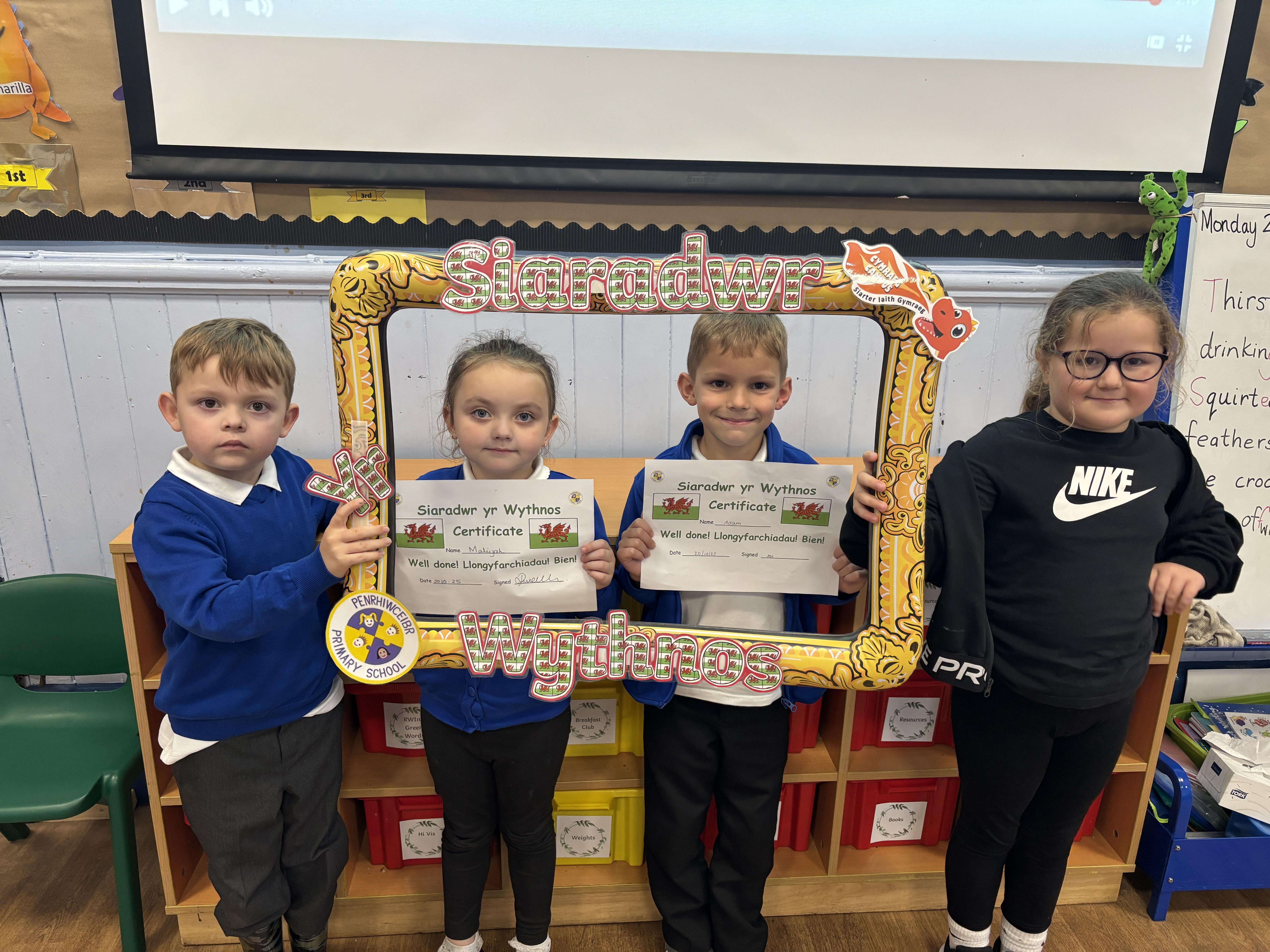 Here are our Criw Iaith handing out the weekly Siaradwr yr Wythnos certificates 